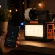 Daudzfunkcionāla LED kempinga lampa ar saules paneli, FM radio un Bluetooth, Melna/Oranža